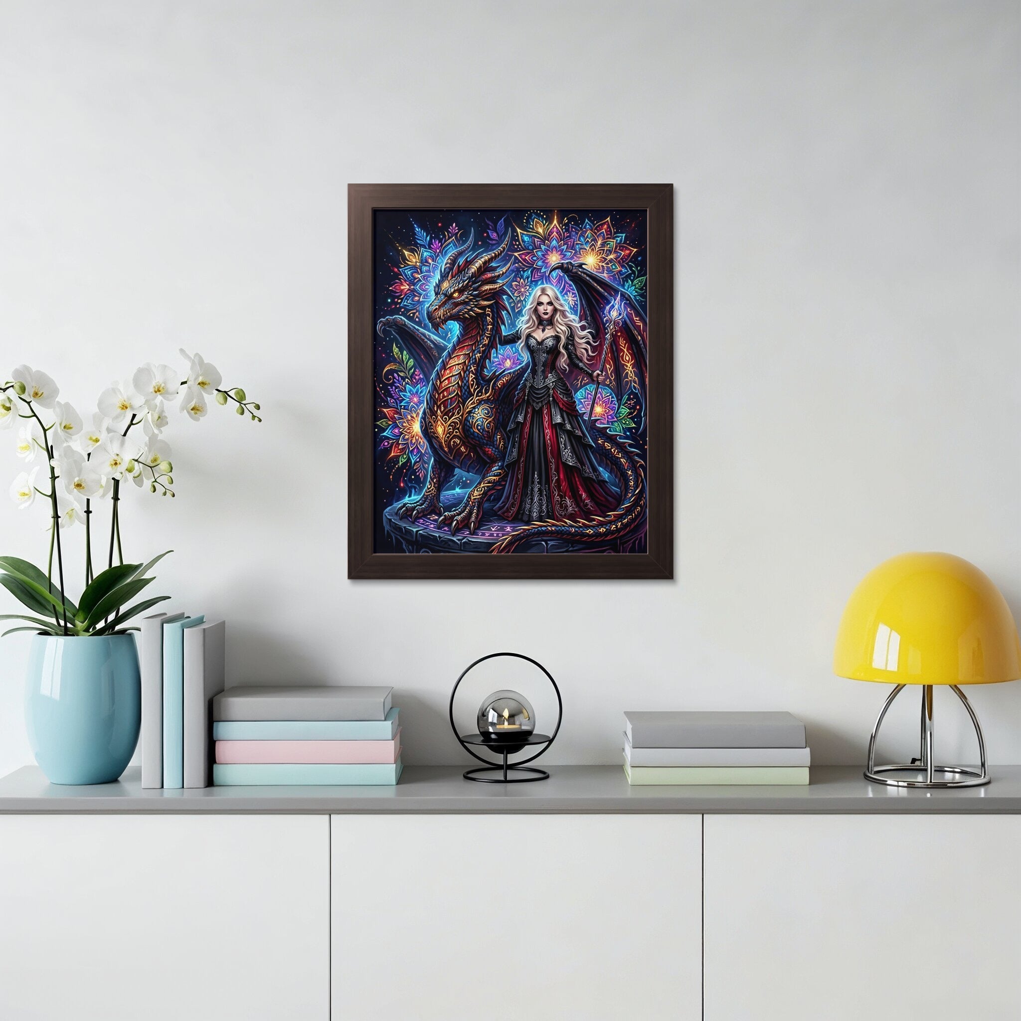 Fantasy art print of a woman with a dragon, displayed on a wall.