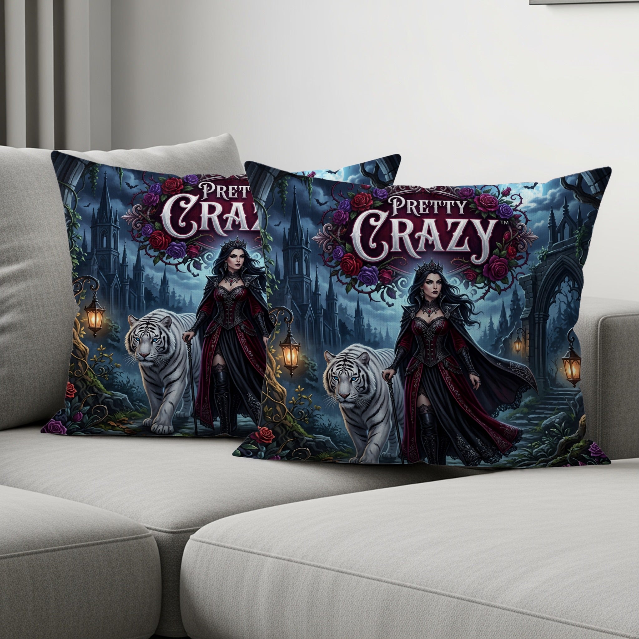 Two decorative pillows featuring a woman and white tigers in a gothic garden setting.